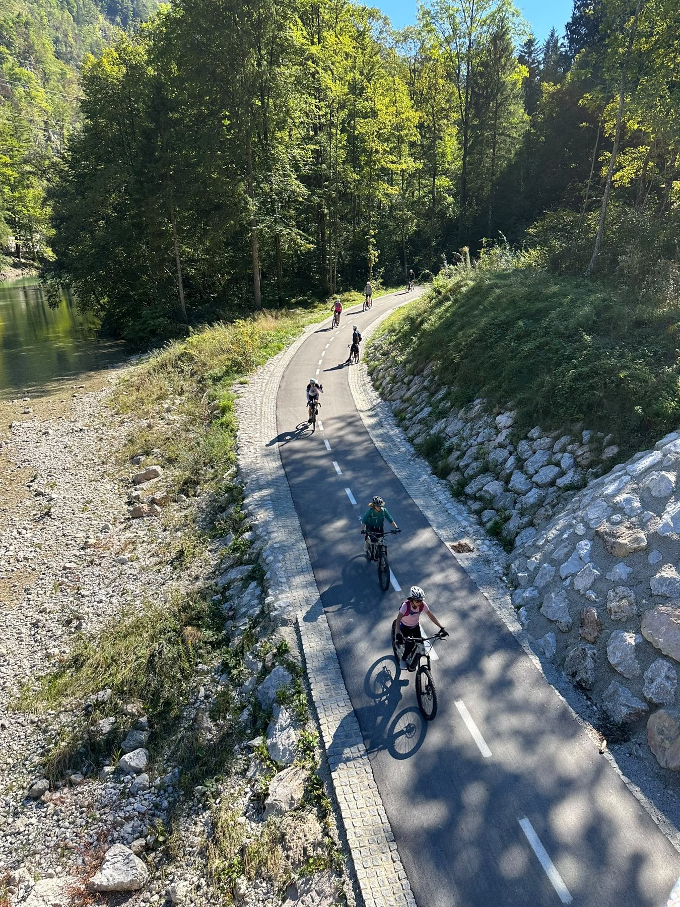 Cyclists riding on a quiet alpine cycling path in Slovenia